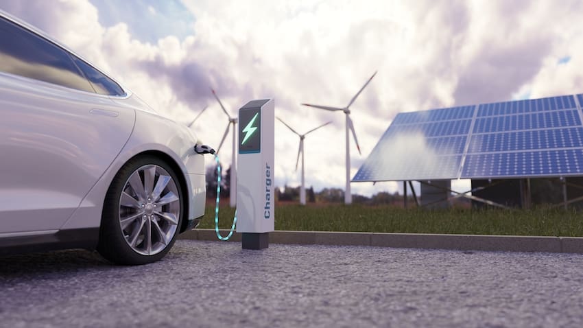 Using of charge station, solar panel and windmill background.