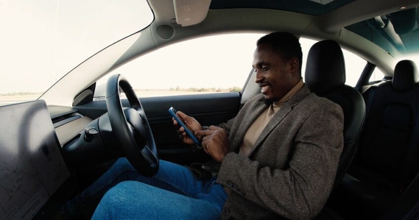 Concentrated,Young,African,American,Male,Sitting,In,Modern,Electric,Car