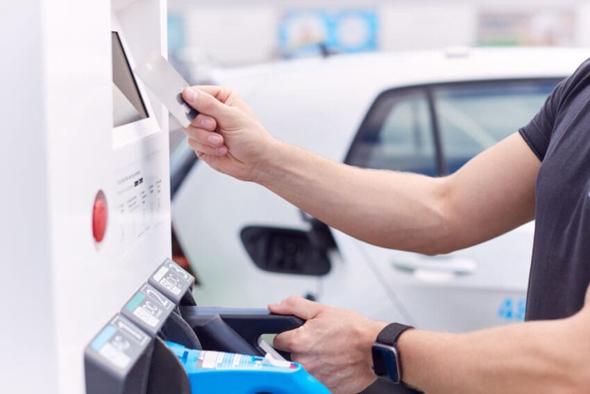 Man,Charging,Electric,Vehicle,Paying,For,Energy,With,Credit,Card