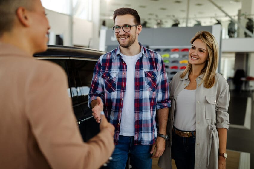 Handsome,Man,Shaking,Hands,With,Beautiful,Saleswoman,After,Buying,A