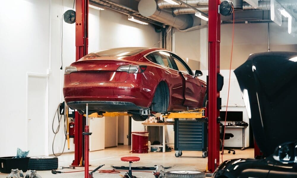 a used EV on a workshop lift